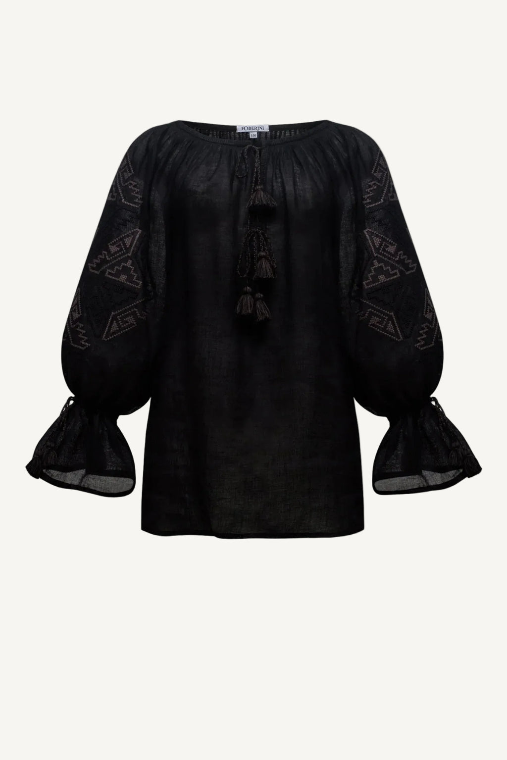 Black blouse with sheer sleeves on a light gray background