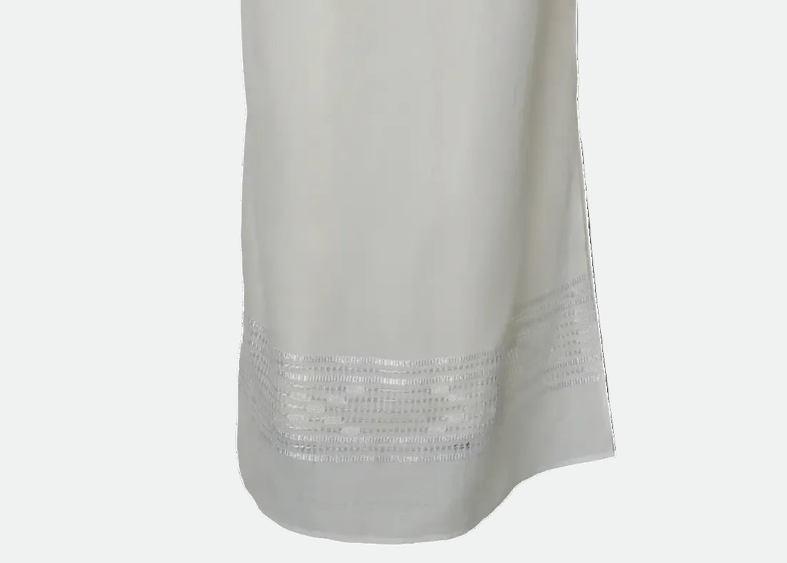 A long white or off-white dress with three-quarter sleeves and horizontal embroidered or lace-like bands across the bodice and skirt,CRAFTED BY ARTISANS OF BLOUSE ROUMAINE SHOP