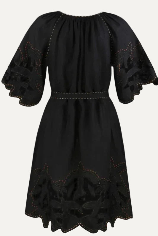 Black dress with floral embroidery on a gray background