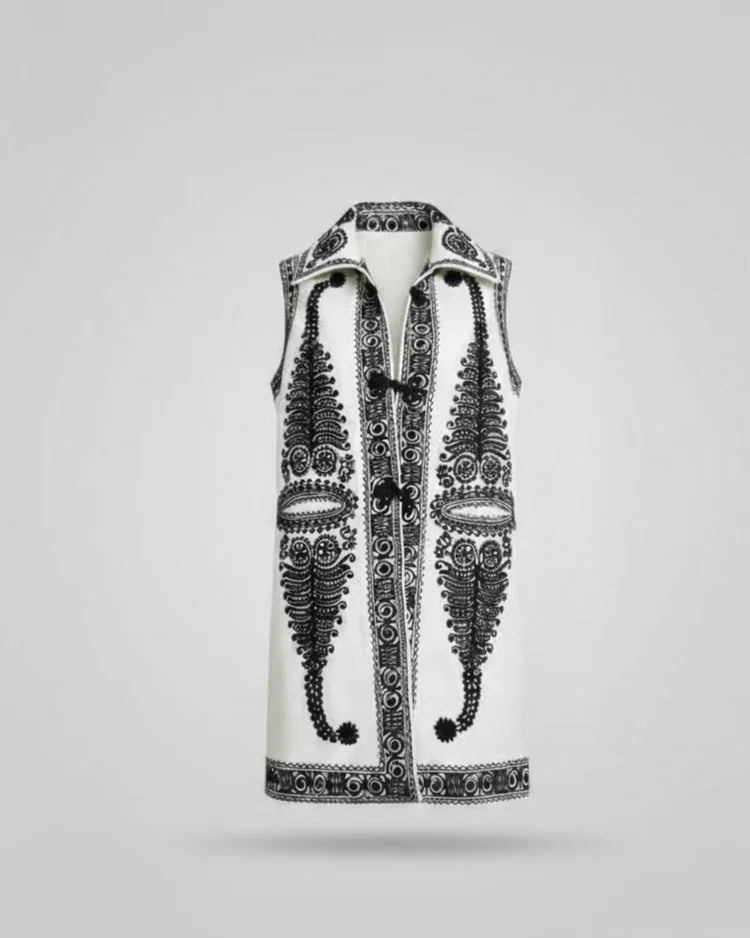 Decorative vest with intricate black patterns on a light gray background