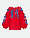 Red blouse with blue floral embroidery on a white background