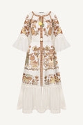 White dress with intricate brown and green patterns embroidery