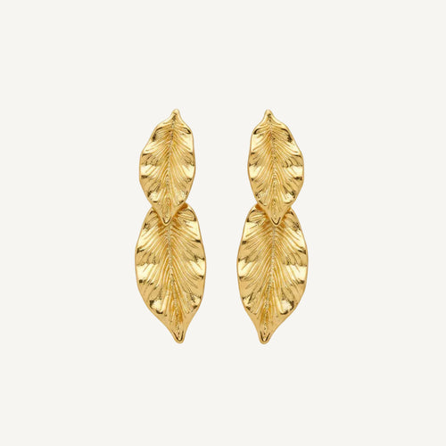 Gold leaf-shaped earrings on a white background