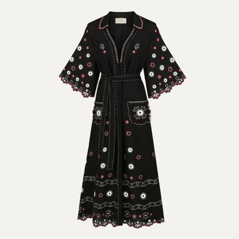 Black dress with white and pink floral patterns on a white background