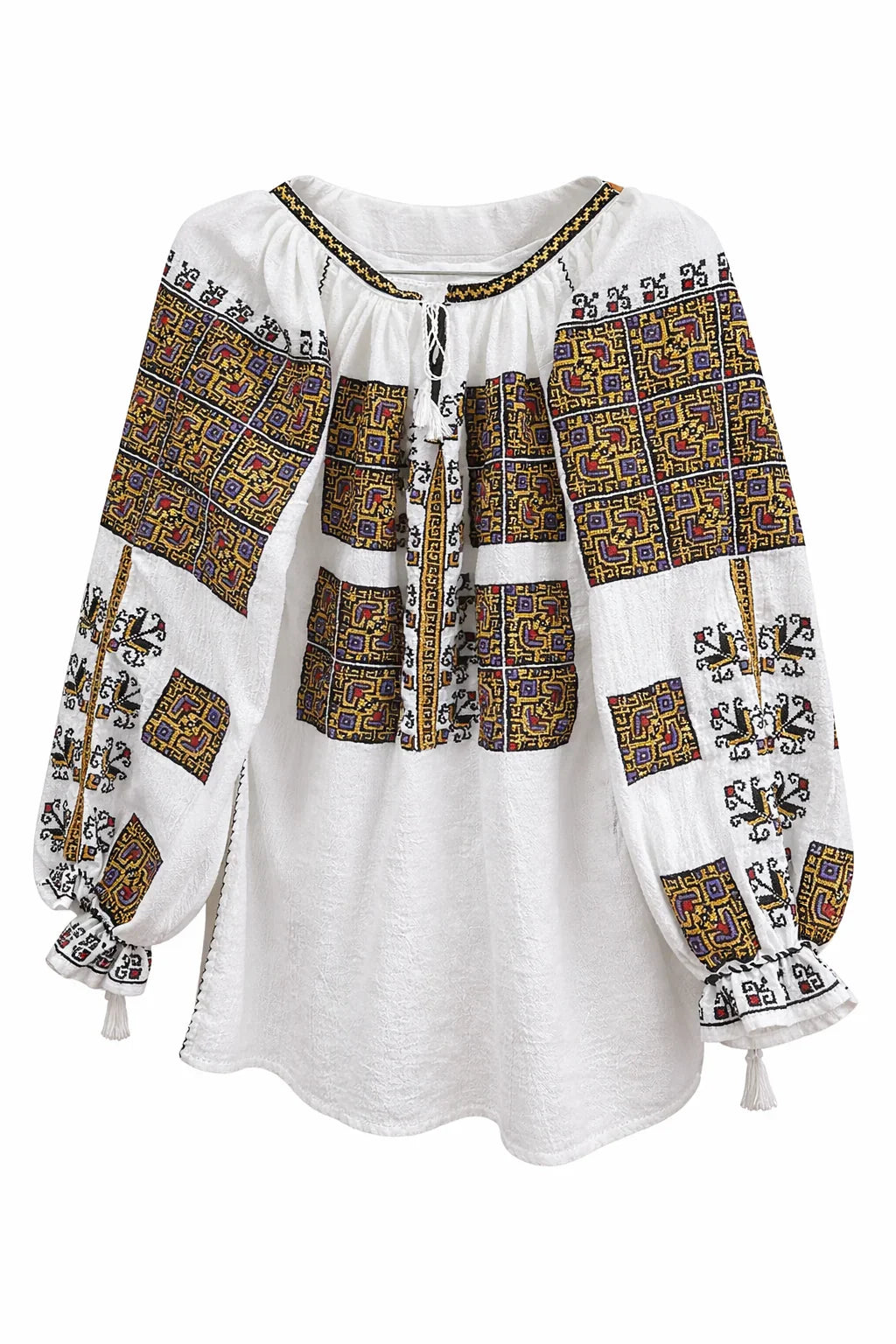 White blouse with intricate black and gold patterns on a white background