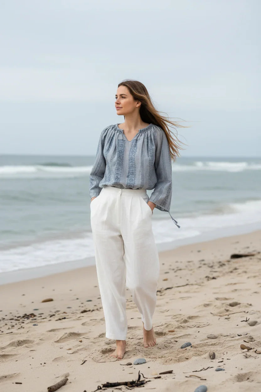 Woman standing on a beach wearing a Romanian Blouse