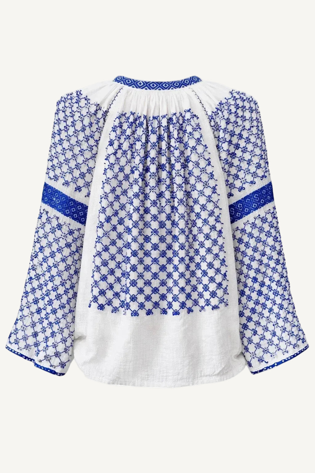 White blouse with blue floral patterns on a white background