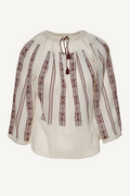 White blouse with brown embroidery on a white background