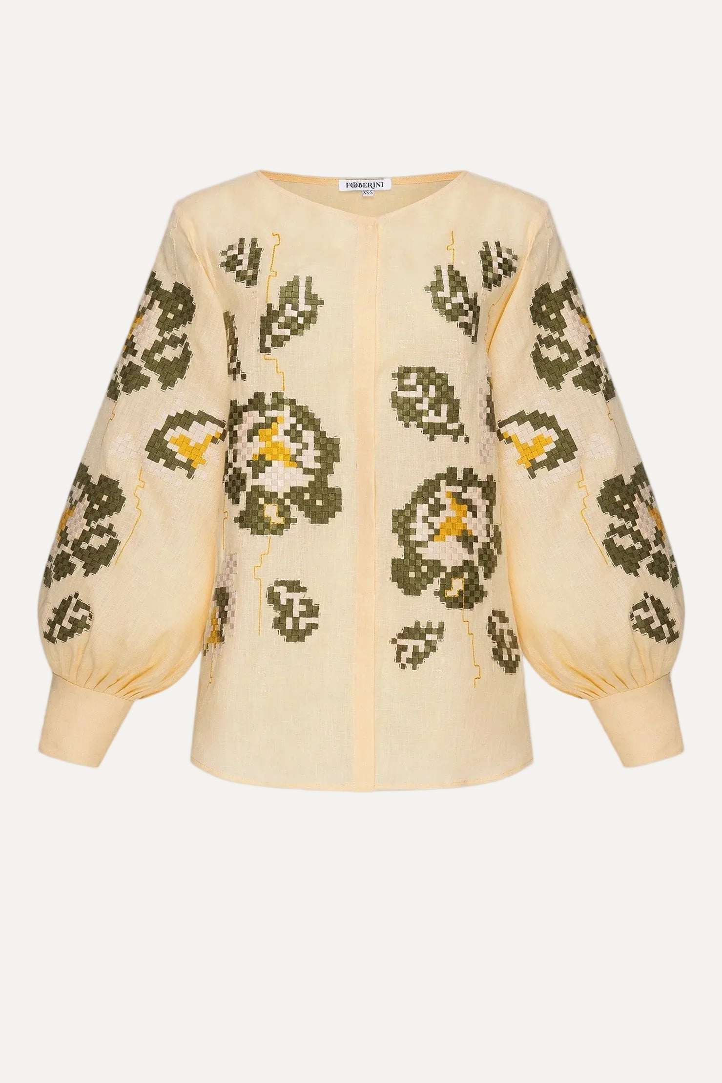 Beige blouse with green floral patterns on a white background