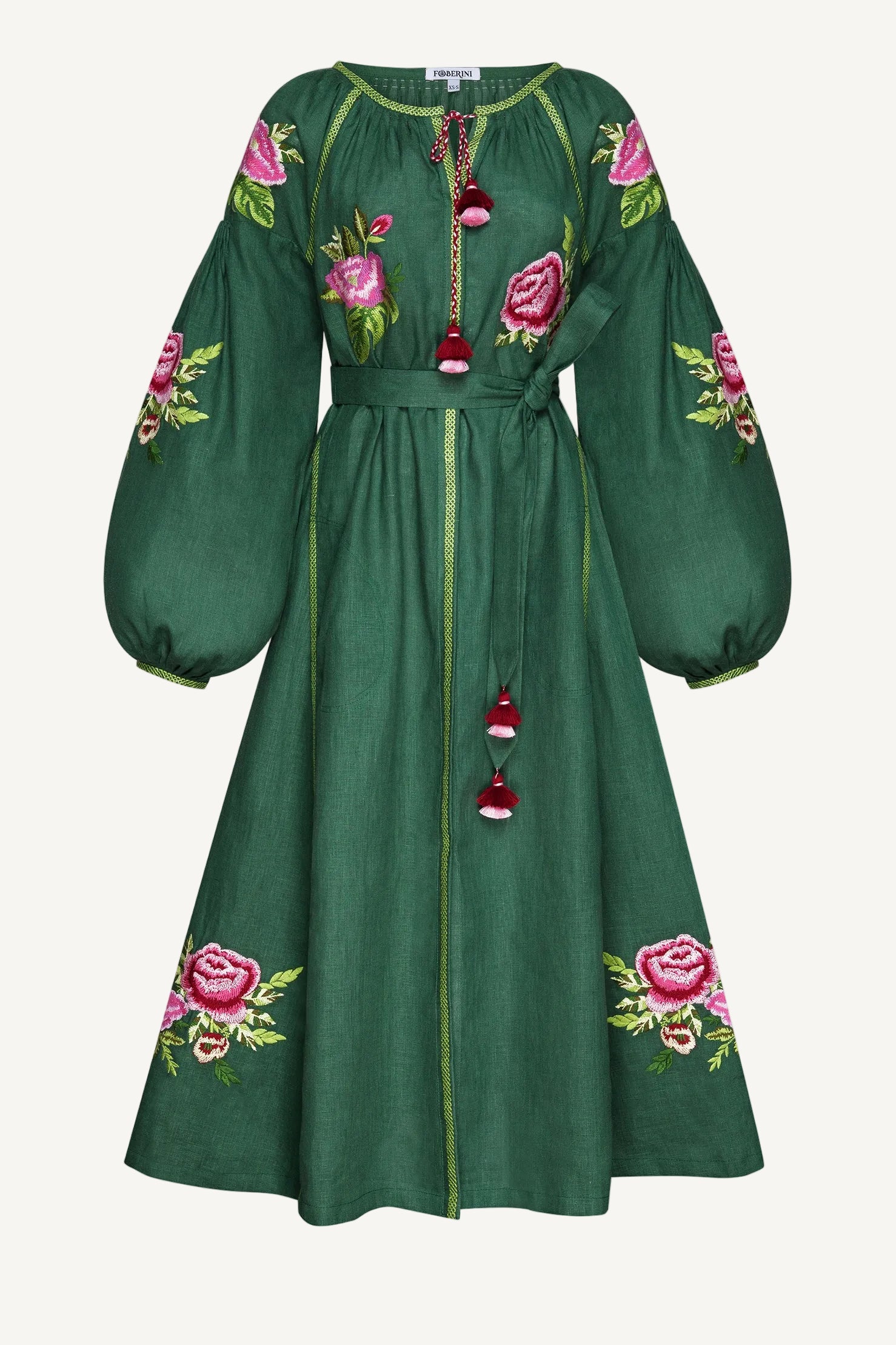 Green dress with floral embroidery on a white background