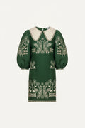 Green dress with white embroidery on a white background