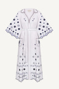 White dress with black floral embroidery The pattern is inspired by the painting Tiger Tiger Burning Bright by artist Beth Rodway, reinterpreted through artisanal craftsmanship.