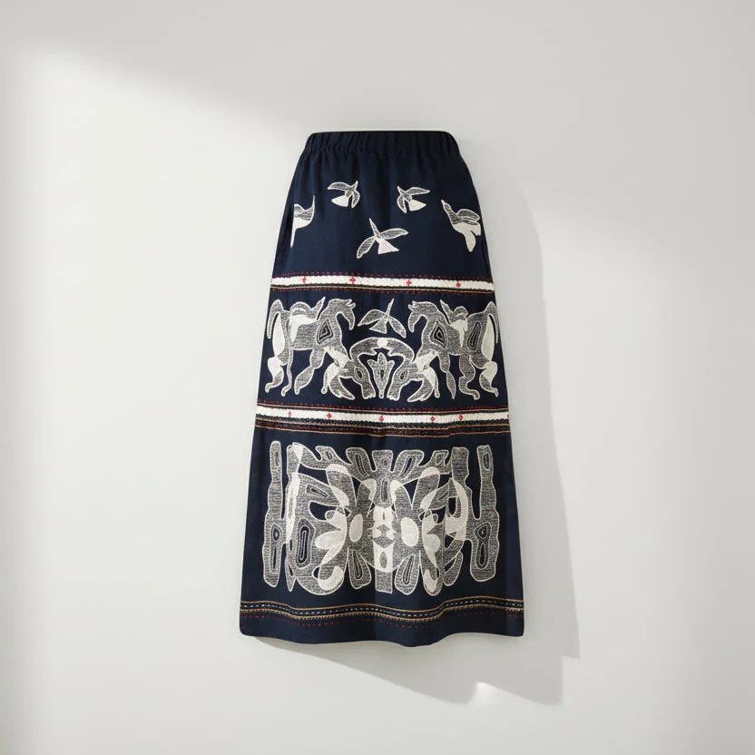 Navy blue skirt with white floral patterns on a white background