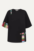 Black t-shirt with colorful floral embroidery crafted by artisans