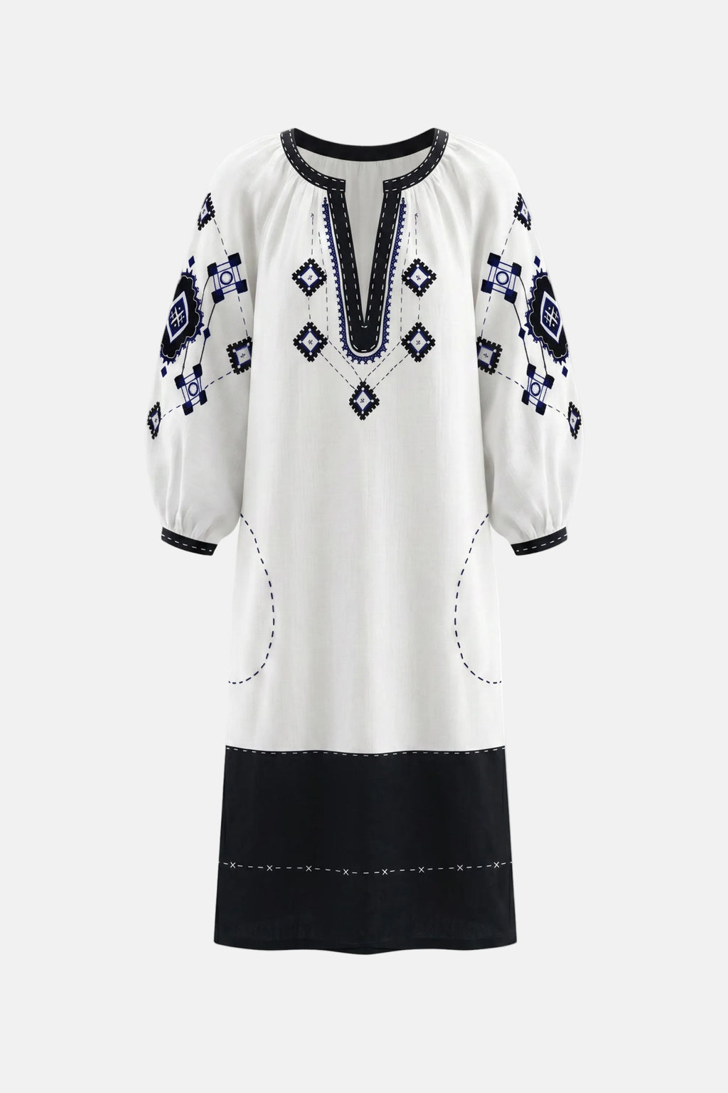 White dress with black and blue embroidery on a white background