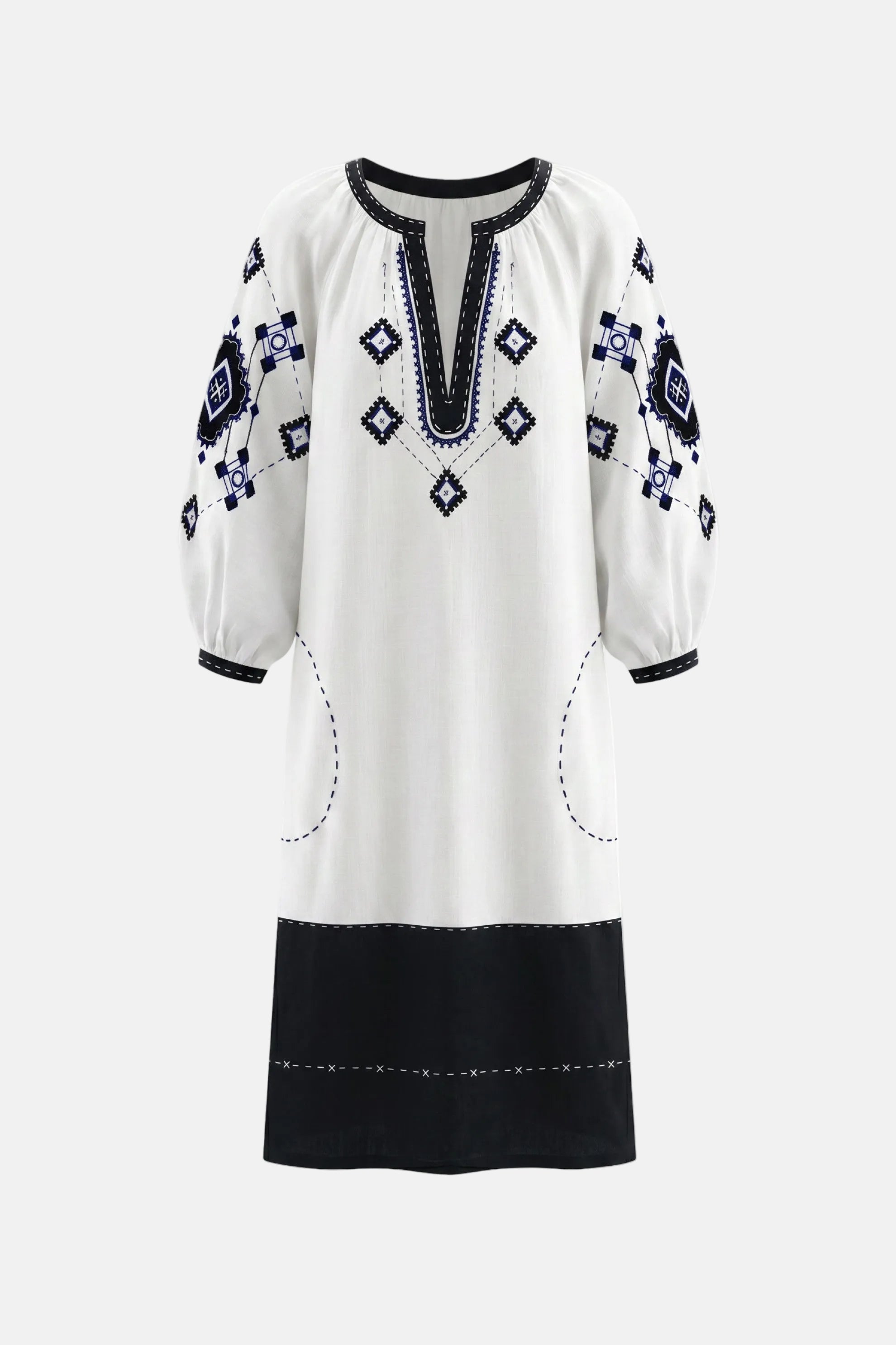 White dress with black and blue embroidery on a white background
