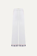 White pants with decorative hem embroidery