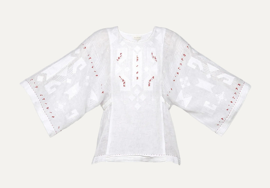 White blouse with red embroidery on a gray background