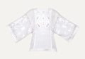 White blouse with red embroidery on a gray background