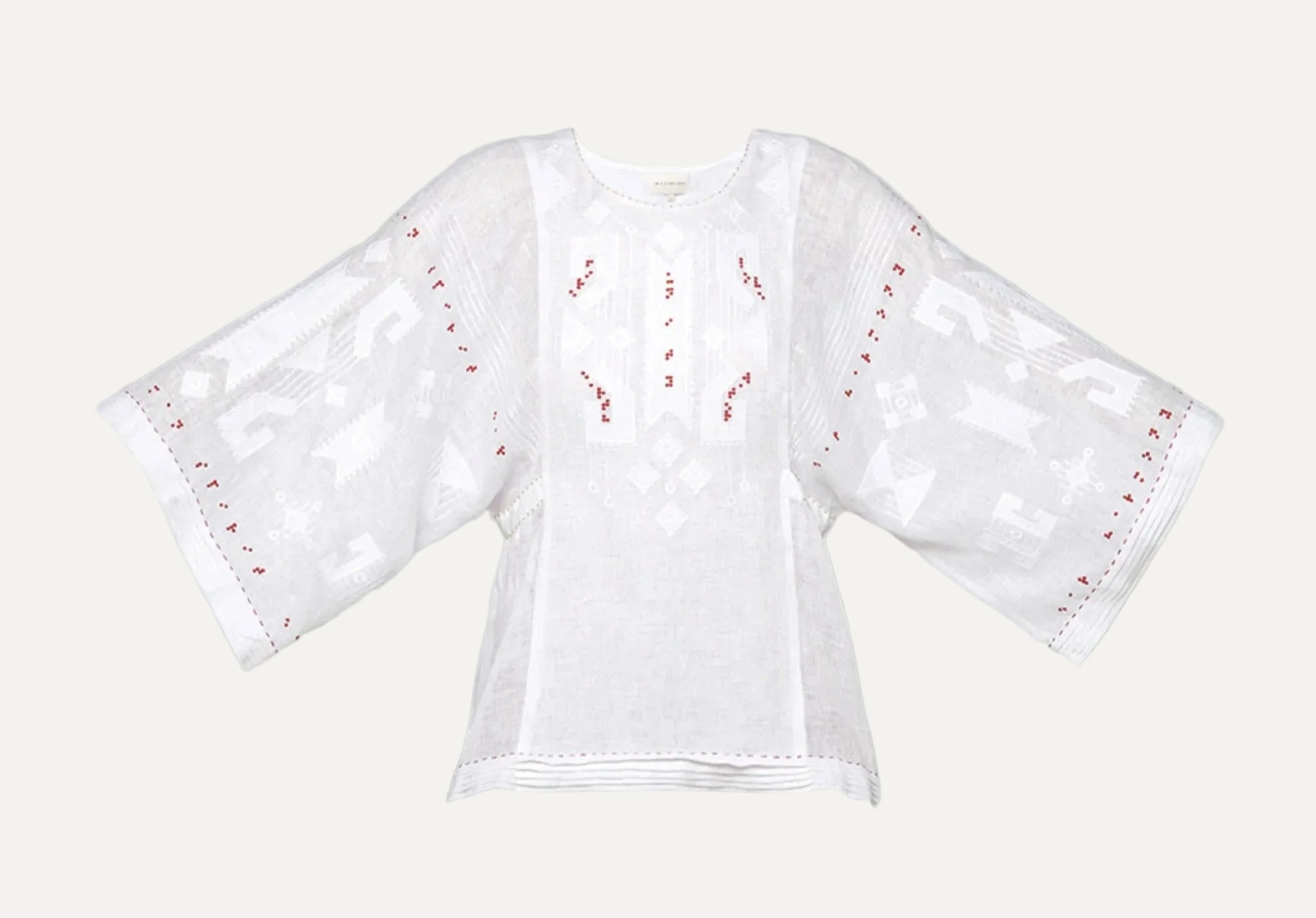 White blouse with red embroidery on a gray background