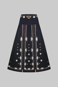 Black skirt with intricate white embroidery on a white background
