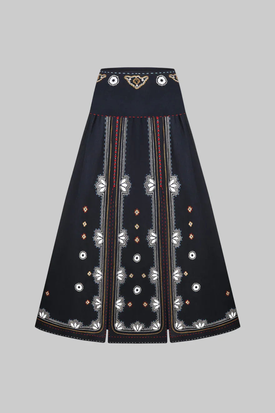 Black skirt with intricate white embroidery on a white background