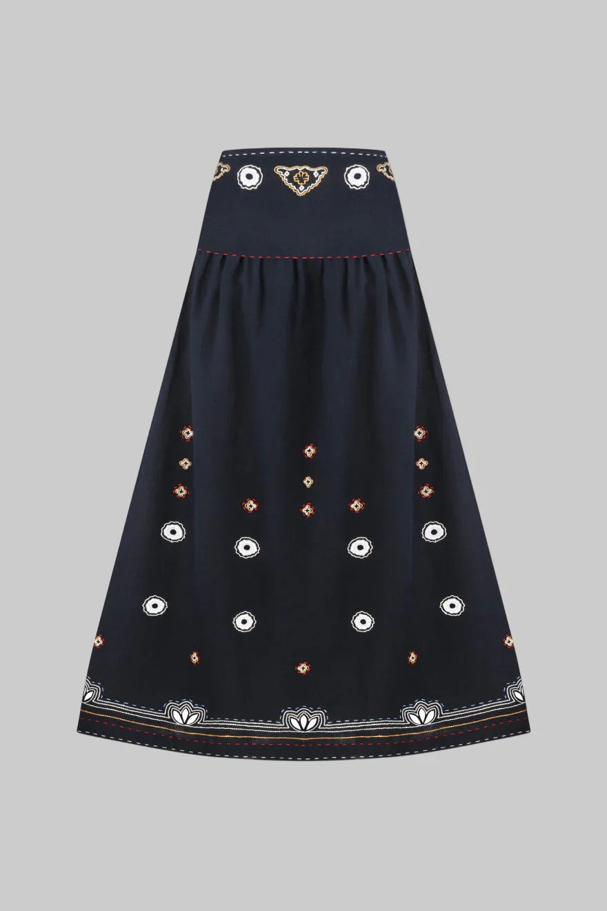 Navy blue skirt with decorative patterns on a white background