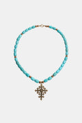 Turquoise beaded necklace with a decorative cross pendant
