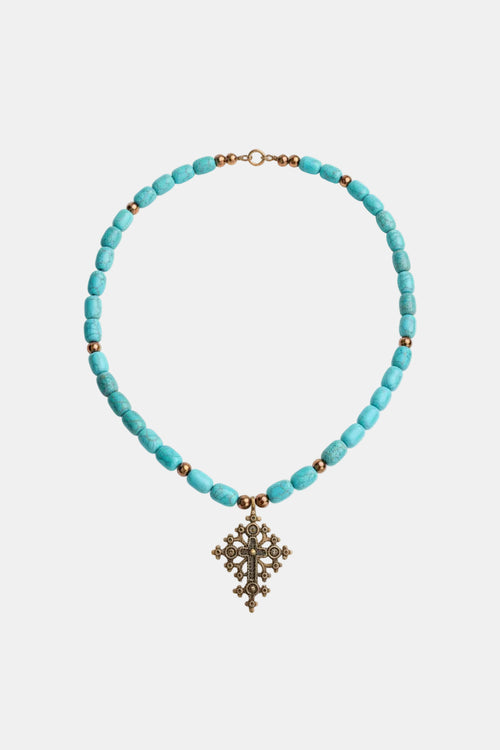 Turquoise beaded necklace with a decorative cross pendant