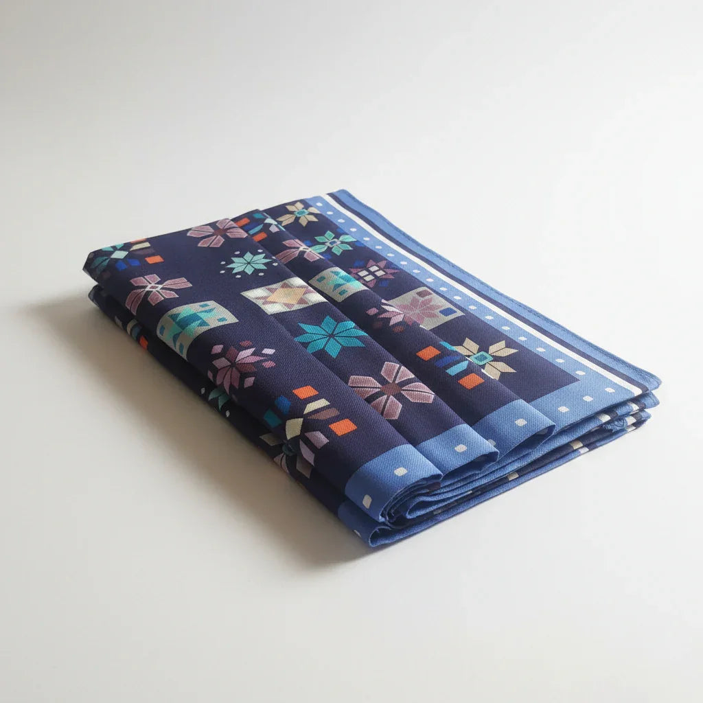 Close-up of patterned fabric with geometric designs on a blue background