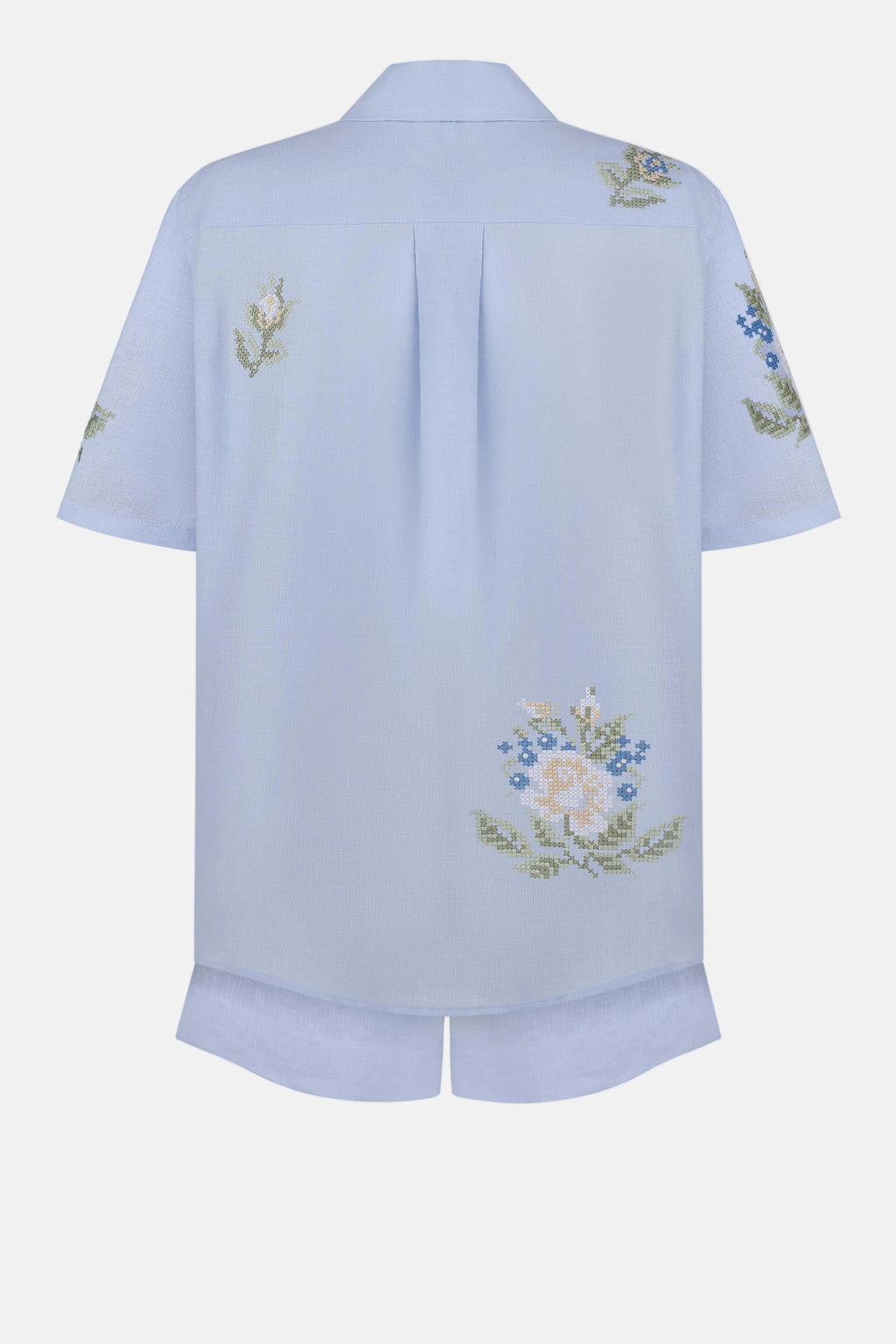 Light blue shirt with floral embroidery on a white background