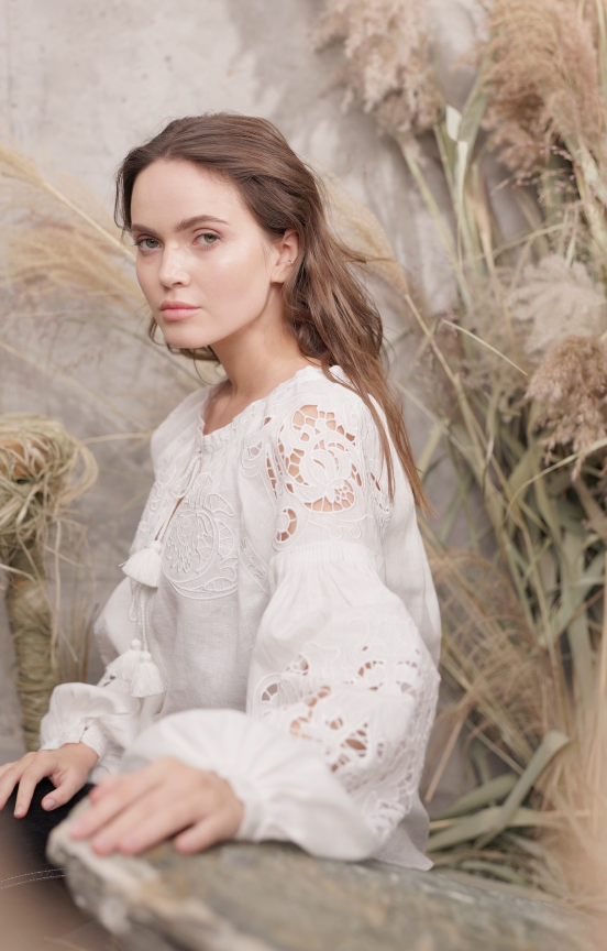 Model wearing Foberini Kvitka white linen vyshyvanka blouse