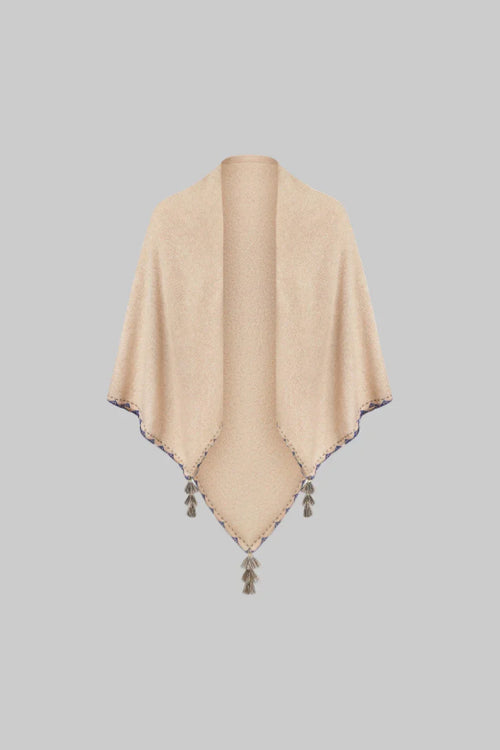 Beige poncho with tassels on a white background