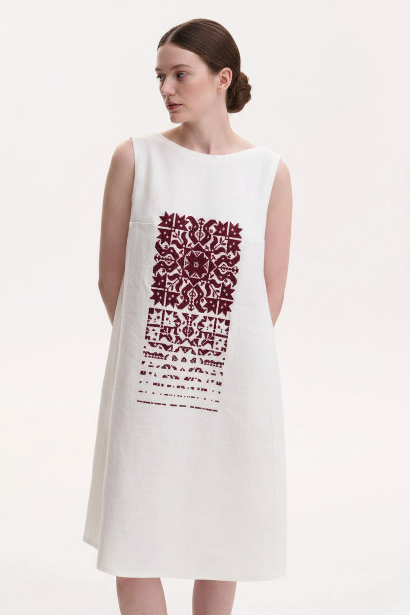 White sleeveless dress with red pattern
