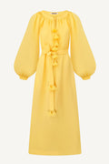 A bright yellow midi dress with long balloon sleeves, a gathered round neckline, and decorative tassel details down the front and at the waist, shown on a plain white background.