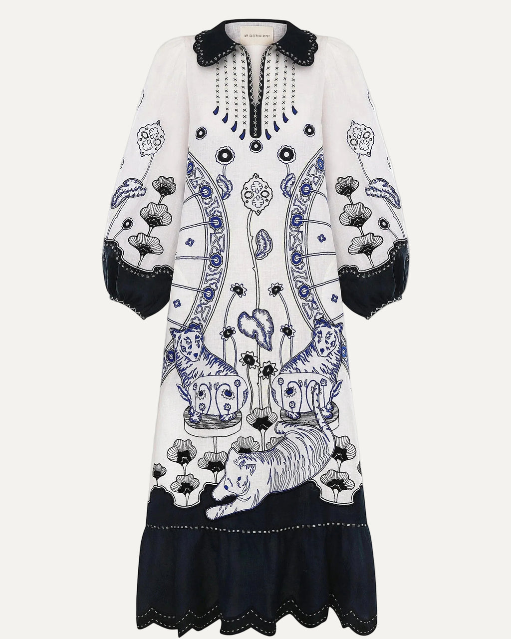 White dress with black and blue floral patterns on a white background