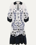 White dress with black and blue floral patterns on a white background