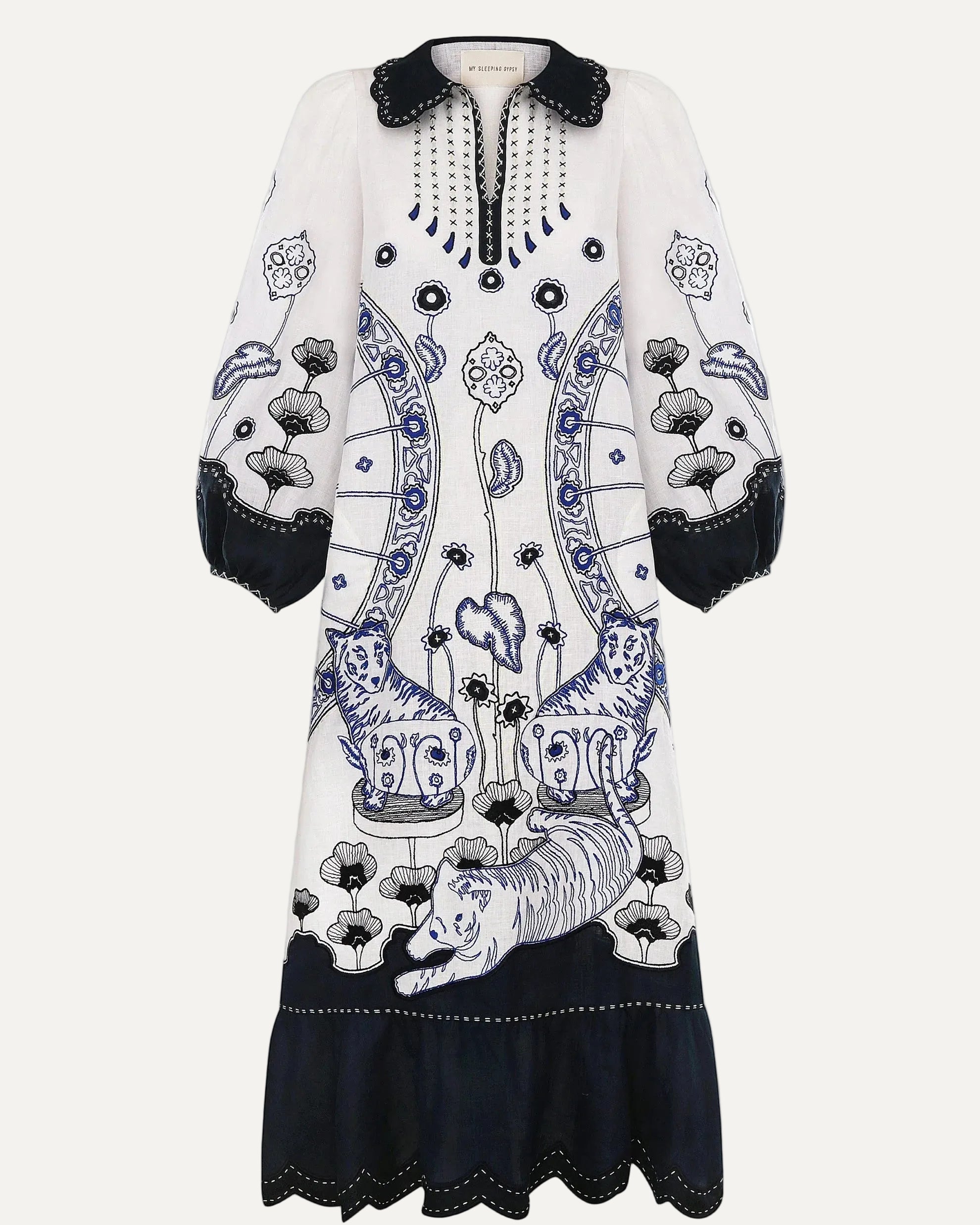 White dress with black and blue floral patterns on a white background