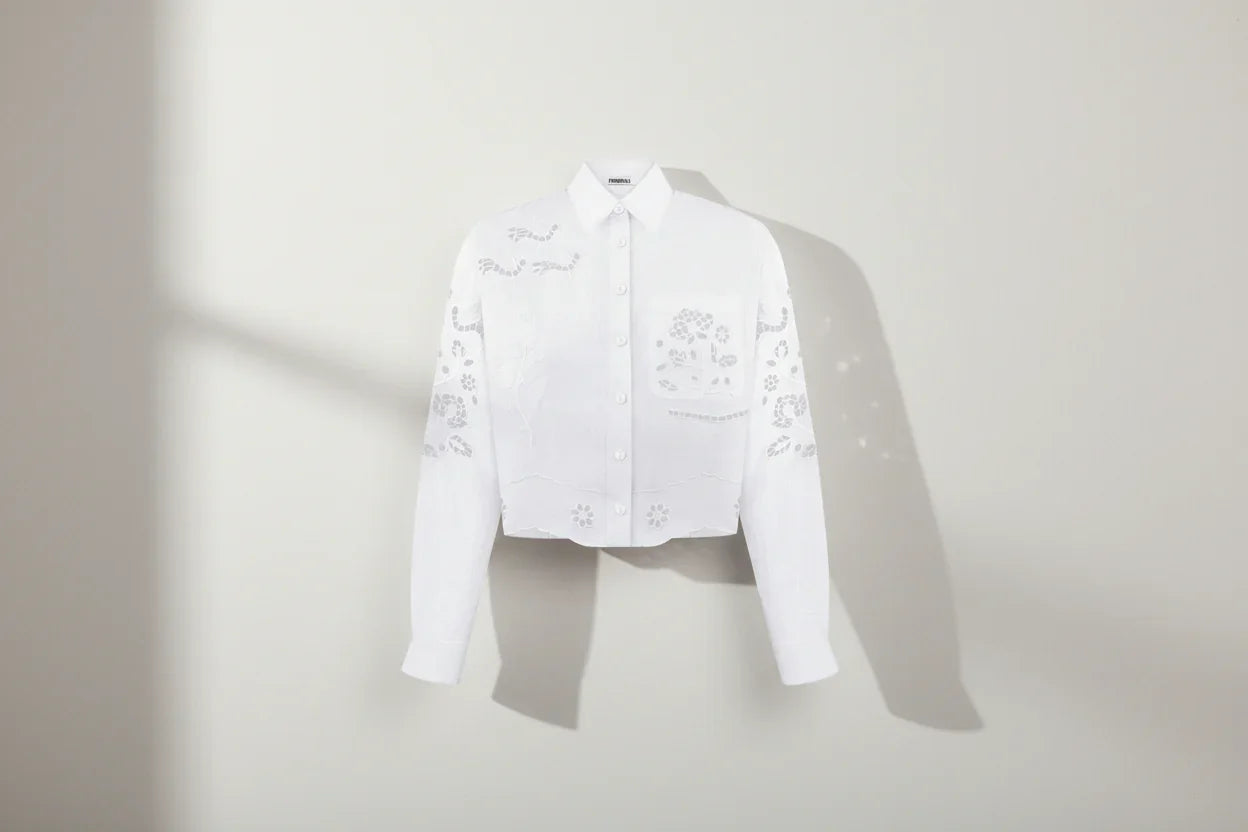 White shirt with floral embroidery on a white background