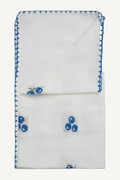 White handkerchief with blue embroidery on a light gray background