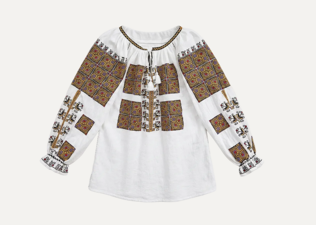 Traditional embroidered blouse on a white background